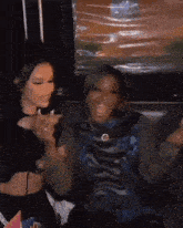 a group of women are sitting on a couch laughing