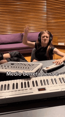 a girl wearing headphones is playing a keyboard with the words medio berreta nena e on it