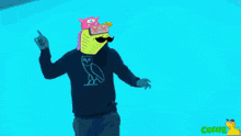 a man wearing a black sweater with an owl on it dancing