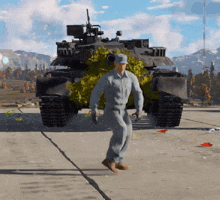 a man is walking in front of a tank that is covered in leaves