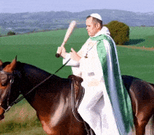 a man riding a horse holding a bat