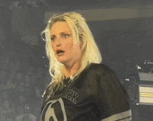 a woman wearing a new york jersey looks shocked