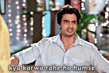 a man with his arms outstretched and the words kya karwa rahe ho humse written below him