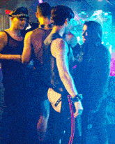 a group of men are standing in a dark room and one of them is wearing a thong