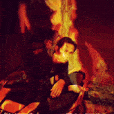 a painting of a man sitting on a motorcycle with a flame behind him