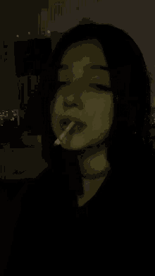 a girl with a cigarette in her mouth and a piercing in her lip