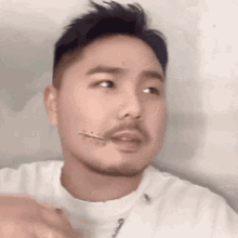 a close up of a man 's face with a tattoo on his face