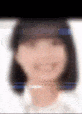 a blurry picture of a woman 's face with a hat on