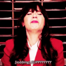a woman in a red jacket is saying sobbing puppyyyy