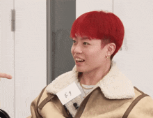 a man with red hair and a name tag that says ' x ' on it