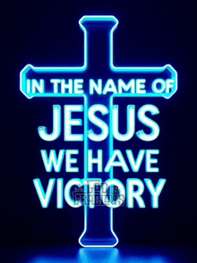 a neon sign with a cross and the words `` in the name of jesus we have victory ''