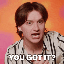 a man in a striped shirt is making a face and says you got it