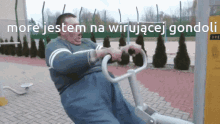 a man is riding a machine with the words more jestem na wirujacej gondoli on the bottom