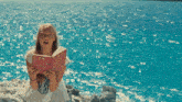 a girl holding a book that says ' i love you ' on it