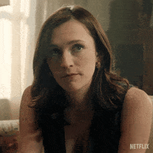 a close up of a woman 's face with a netflix logo on the bottom
