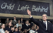 a man in a suit stands in front of a sign that says child left behind