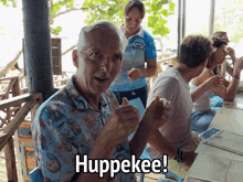 a man in a hawaiian shirt says huppekee in front of a waitress