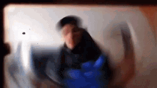 a blurry picture of a man wearing a blue glove .