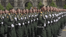a group of soldiers marching in a line with their arms crossed