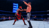 two wrestlers are fighting in a ring with a sign that says impact