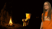 a man giving a thumbs up next to a golden toilet