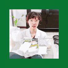 a woman in a lab coat is sitting at a table holding a bag of green beans