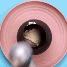 a scoop of ice cream is being scooped out of a chocolate bowl