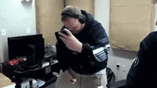 a man wearing headphones is holding a cell phone in his hand