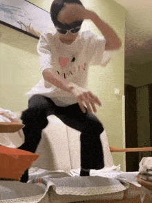 a person wearing sunglasses and a shirt that says i love you