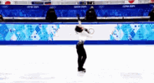 a figure skater is doing a trick on ice