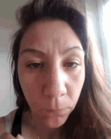 a close up of a woman 's face with a slight smile on her face