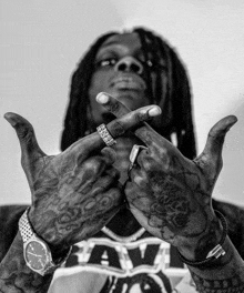 a black and white photo of a man wearing a watch and a shirt that says raw