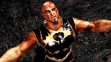 a bald man with a beard is wearing a black and gold armor