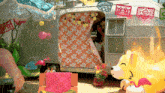 a silver trailer with a floral blanket on the side
