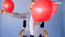 Pop A Balloon Cara Delevingne GIF - Pop A Balloon Cara Delevingne Marie Claire GIFs