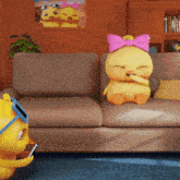 a cartoon duck with a pink bow on its head sits on a couch