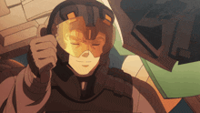 a man wearing a helmet and goggles is giving a thumbs up sign