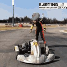 a person standing on a kart with the number 2 on the front