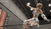 a woman in a wrestling ring with a banner that says hate