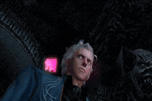 a man 's head is surrounded by glowing pink letters that say ' devil '