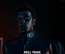 a man with black paint on his face says " hell yeah "