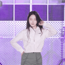 a woman in a white jacket and green pants is dancing