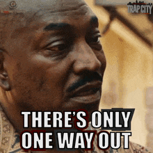 a man says " there 's only one way out " in front of a trap city logo