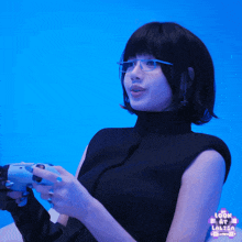 a woman wearing glasses is holding a video game controller with the words look at lolita on the bottom