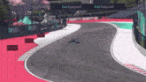 a race car is going down a track with a turbopod sign behind it