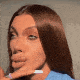 a close up of a woman making a funny face with her hand on her chin