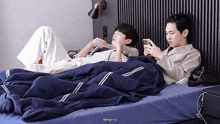 two men laying on a bed with the word almighty on the bottom left