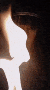a close up of a woman 's face with a light coming out of her mouth .
