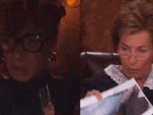 a woman with glasses is holding a fork next to another woman with glasses