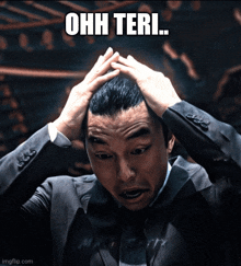 a man in a suit has his hands on his head and the words ohh teri are above him